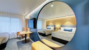 A hotel room with two beds, a TV, a desk, and a large mirror. - Distinction Whangarei Hotel & Conference Centre (Whangarei)