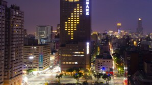A high-rise building with illuminated windows and a prominent sign. - Howard Plaza Hotel Kaohsiung (Kaohsiung)