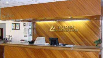 A reception desk with a wooden finish, a reception area, and a sign that reads "MALLARD GROUP".