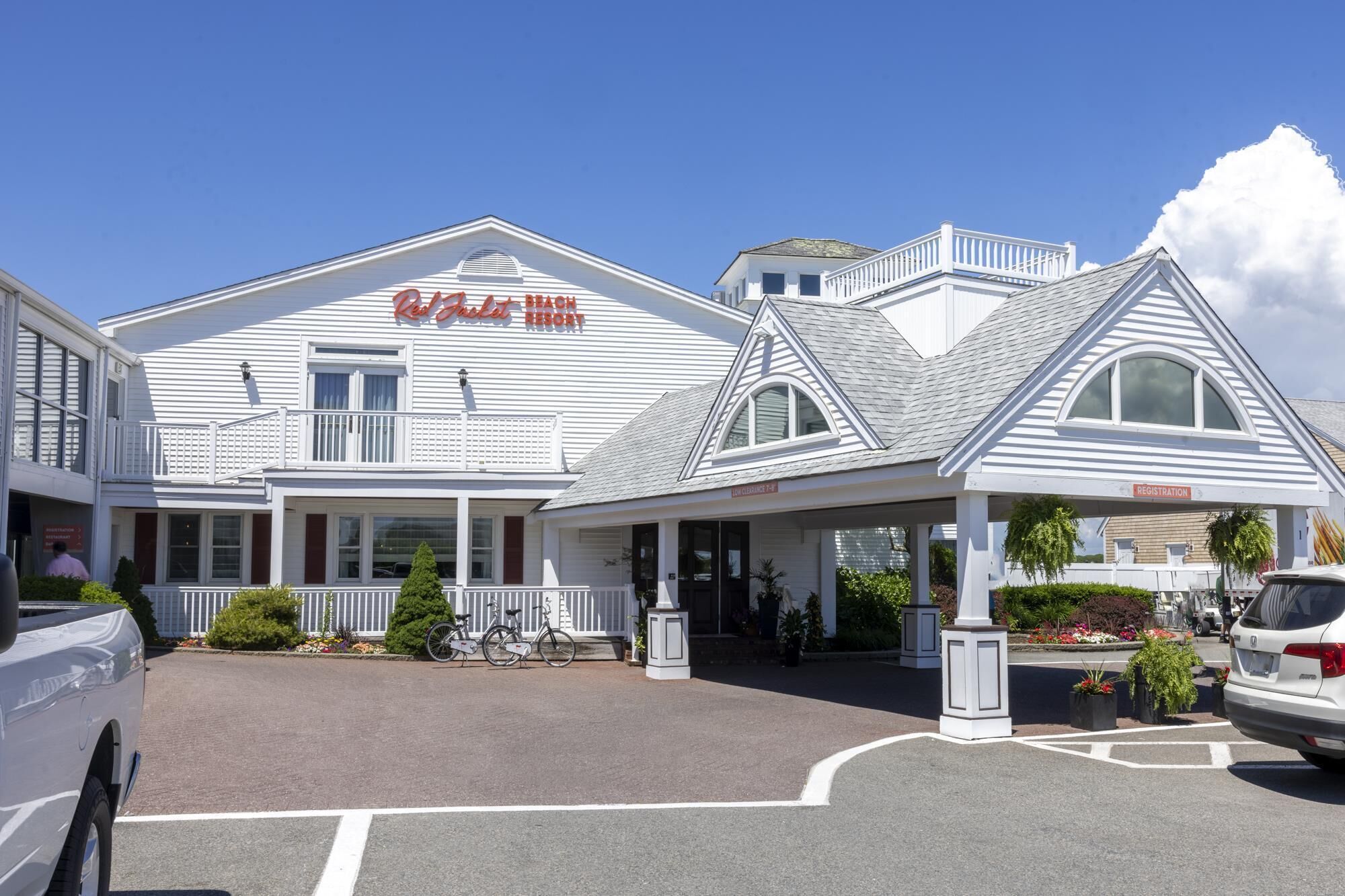 A white building with a sign reading "Red Jacket Beach Resort".