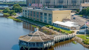 A riverside hotel with a dock and a gazebo.