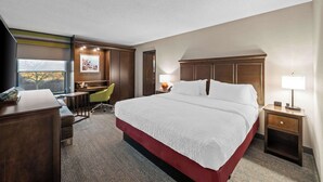 A hotel room with a large bed, a desk, a chair, a TV, and a window with a view. - Hampton Inn by Hilton New Bedford/Fairhaven (Fairhaven)