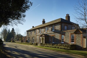 A large stone building with multiple windows and a central entrance. - The Goodwood Hotel (Chichester)