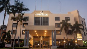 A hotel with a modern facade, a prominent sign, and a well-lit entrance. - Hotel Diana Woolloongabba (Woolloongabba)