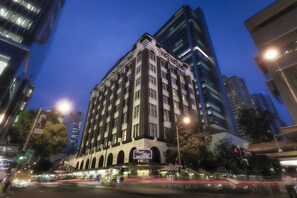 A hotel with a classic facade, multiple floors, and a prominent sign. - Royal Albert Hotel (Brisbane)