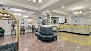 A spacious lobby with a reception desk, seating area, and decorative lighting. - Royal Albert Hotel (Brisbane)