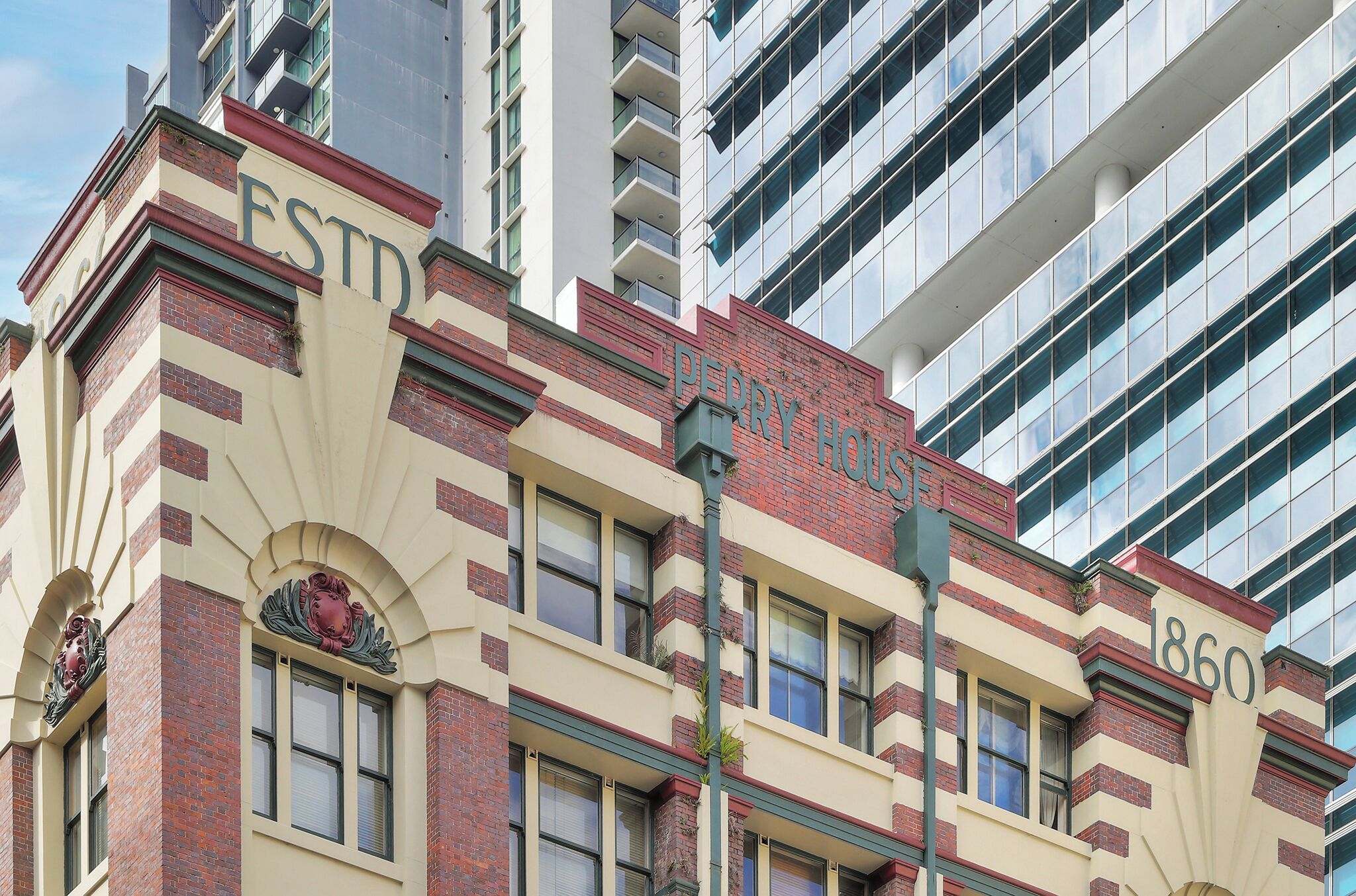 A historic building with the address 1860, featuring a classic architectural style with brickwork and decorative elements.