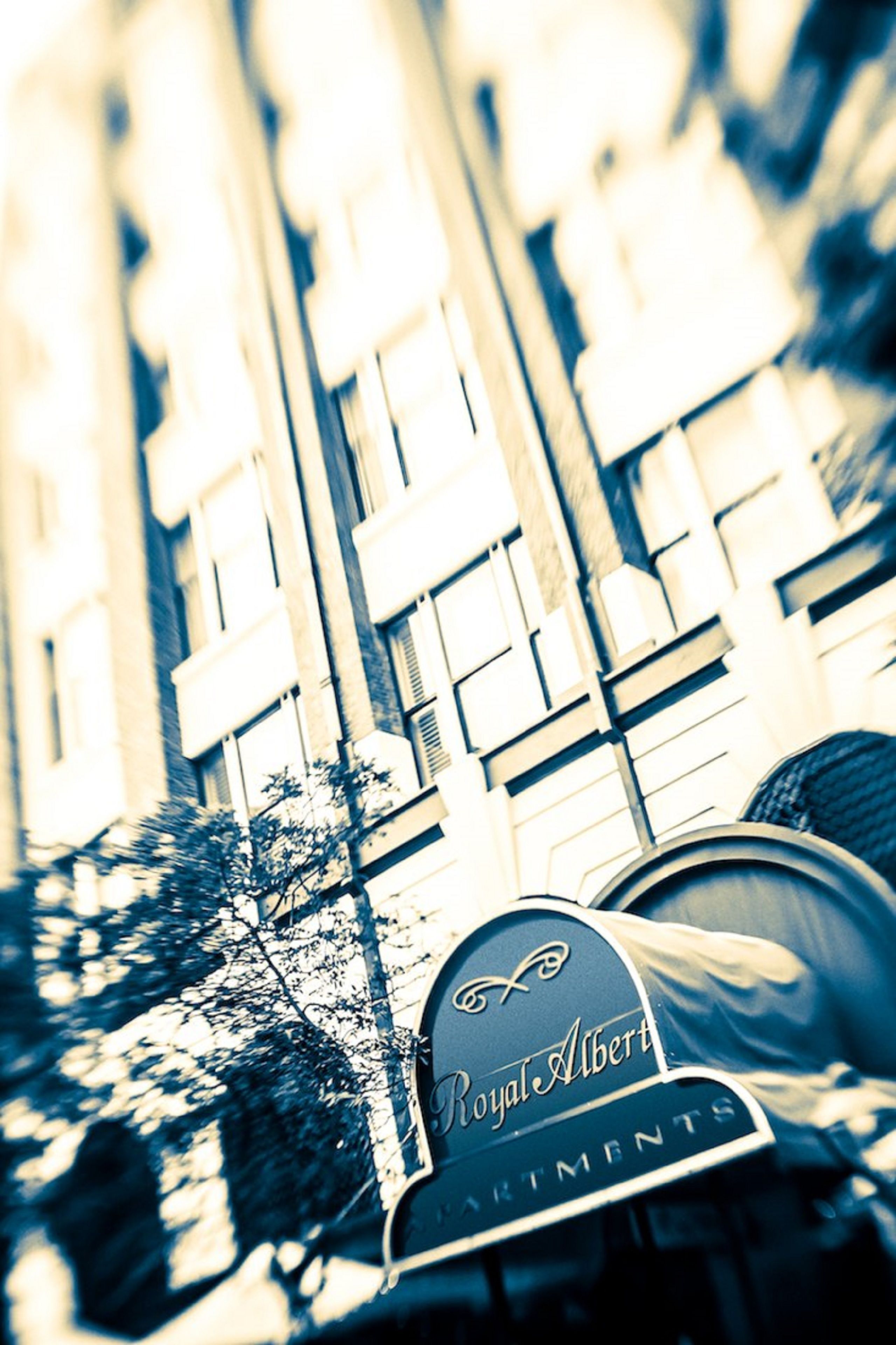 A building with a sign labeled "Royal Albert Apartments."