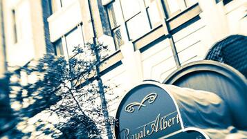 A building with a sign labeled "Royal Albert Apartments."