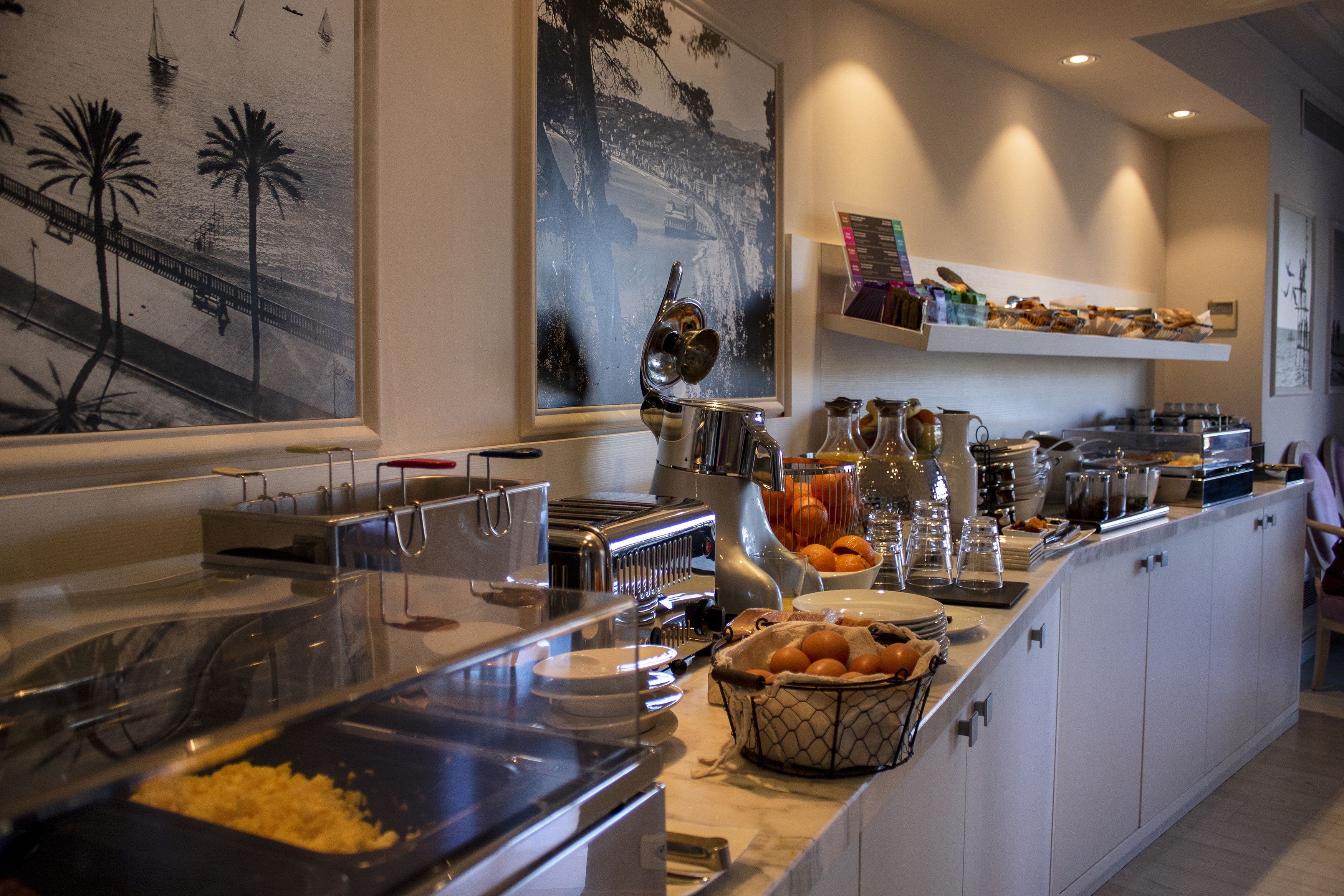 A buffet area with various food stations, including a fruit bowl and a coffee station.