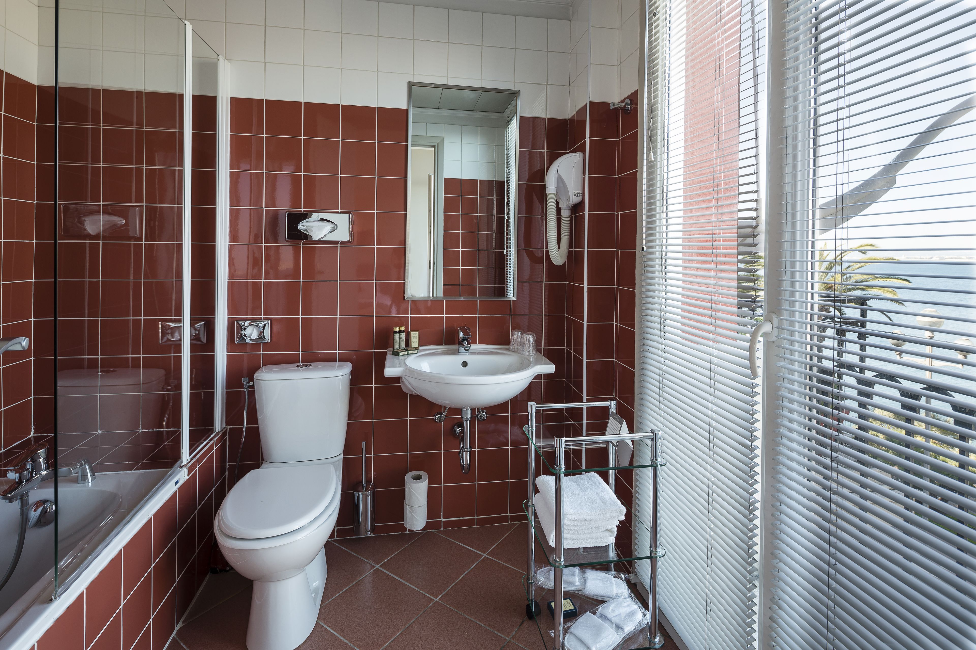 A bathroom with a toilet, sink, and shower.