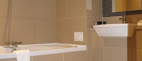 A bathroom with a bathtub, a sink, and a toilet.