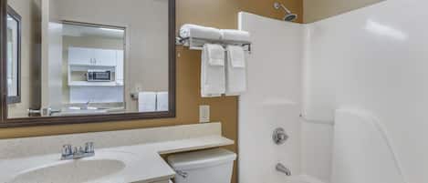A bathroom with a sink, toilet, and bathtub.
