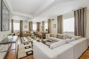 Penthouse Suite, Four Bedrooms Apartment | Living room | LCD TV, DVD player, iPod dock