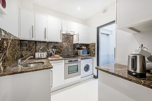 Standard Apartment, 3 Bedrooms (Lower Ground floor) | Private kitchen | Full-size fridge, microwave, oven, stovetop
