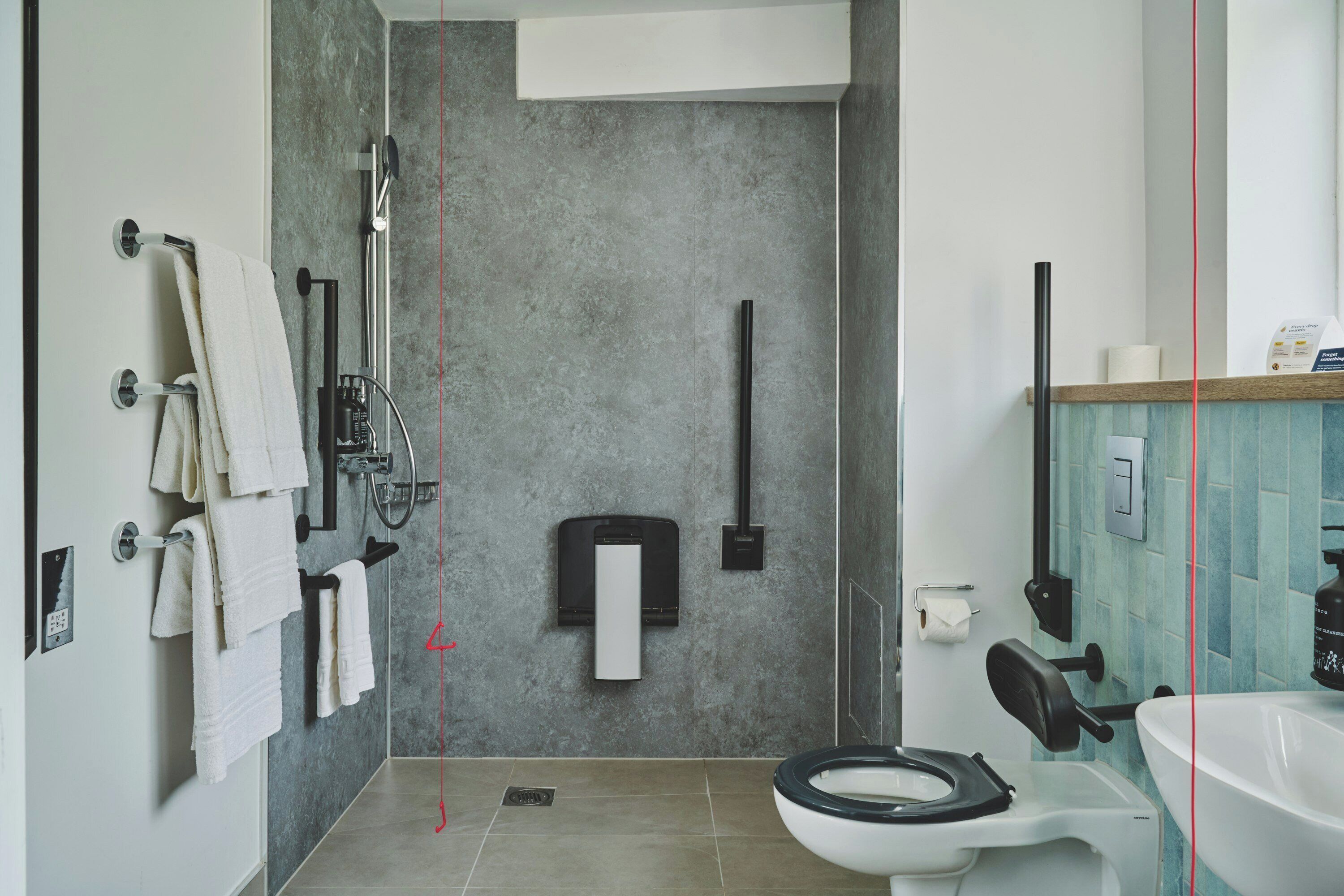 Un baño moderno con ducha, inodoro y lavamanos.