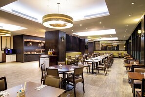 Enjoy meals in this stylish dining area with long tables, comfortable chairs, and a fully equipped kitchen.