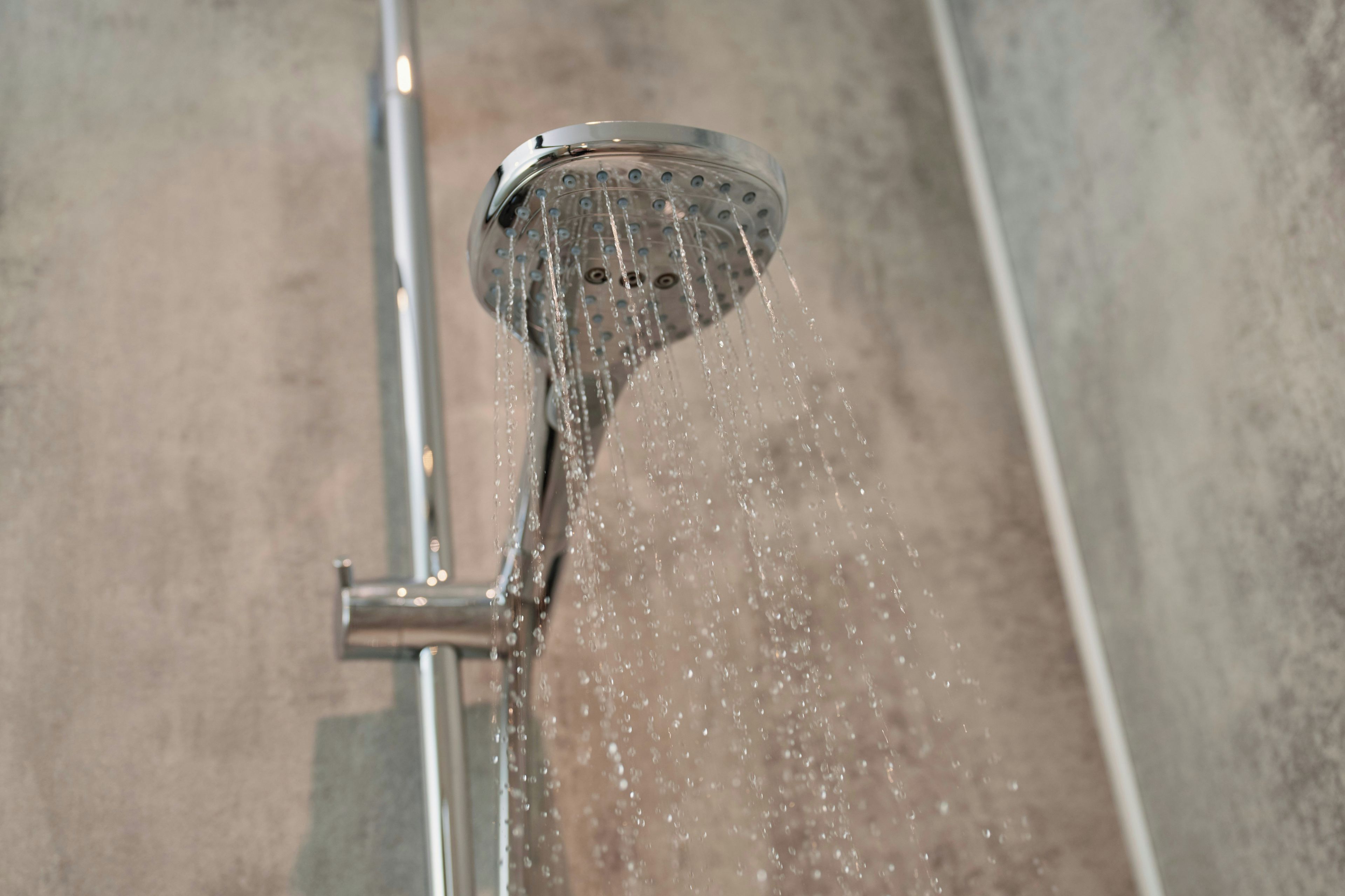 A showerhead with water flowing from it.
