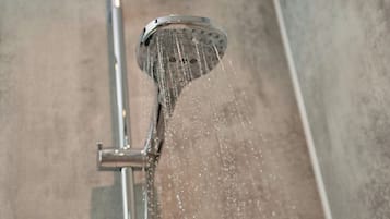 A showerhead with water flowing from it.