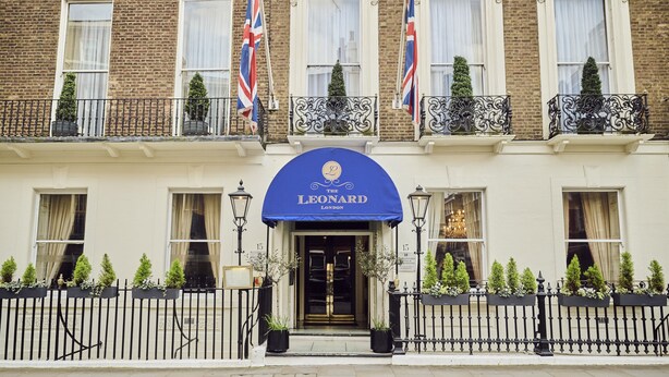 A building with a blue awning displaying "The Leonard London".