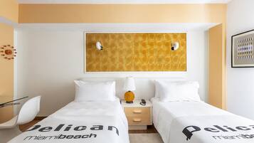 A hotel room with two beds, a nightstand, a lamp, and a wall art piece.