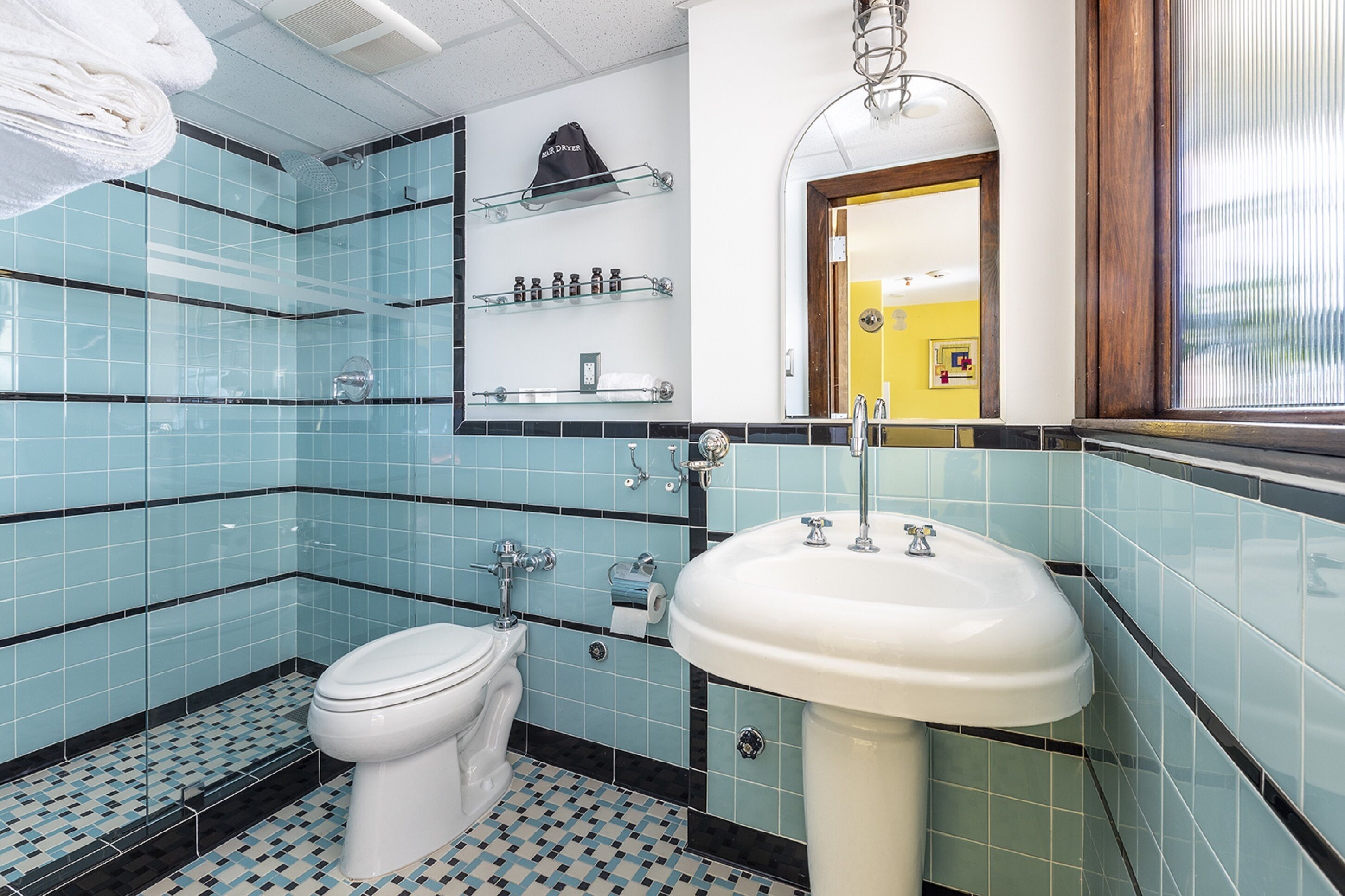 designer toiletries, hair dryer, slippers, towels