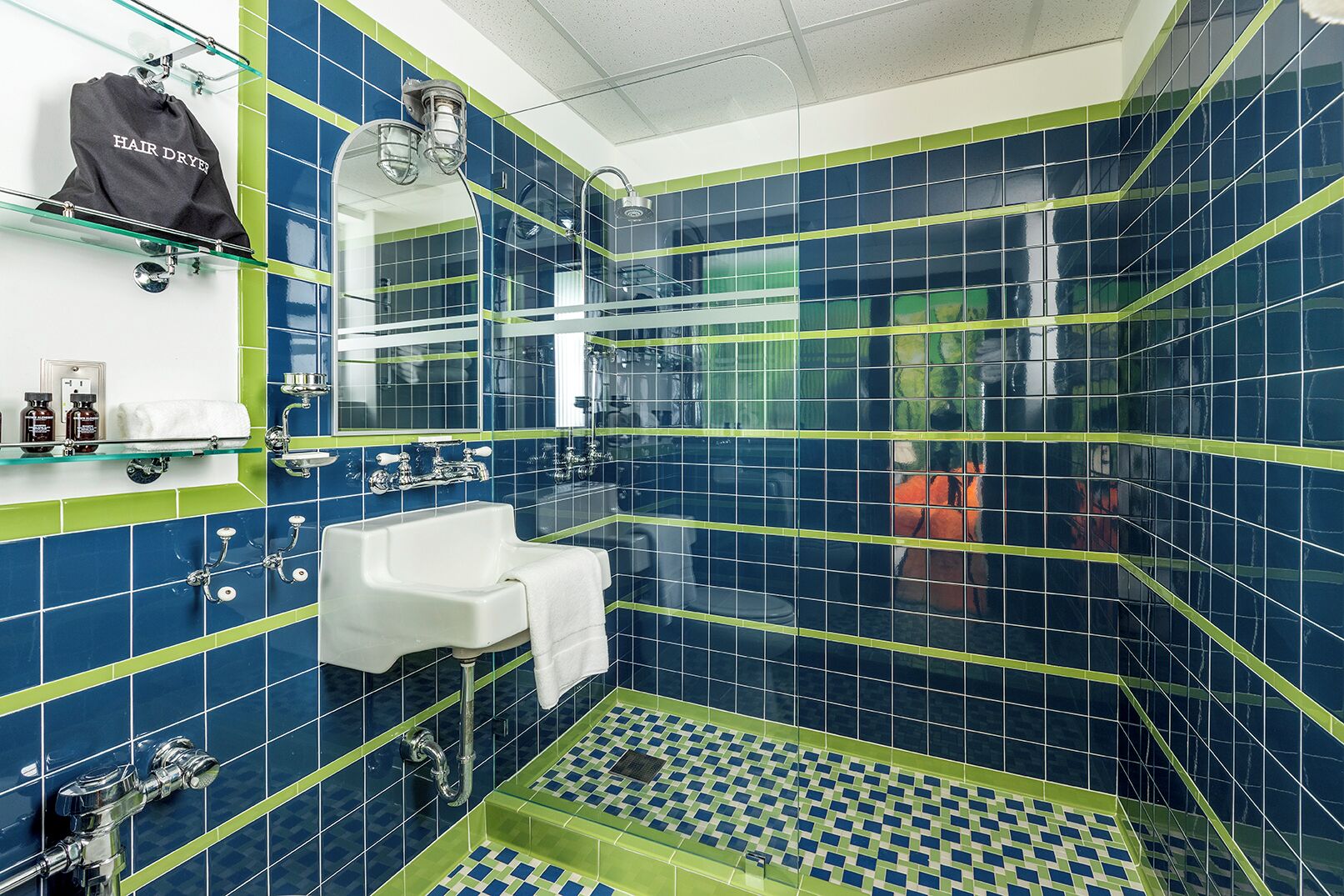 designer toiletries, hair dryer, slippers, towels