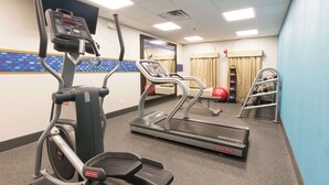 A gym with treadmills, an elliptical, and a stair climber. - Hampton Inn St. Augustine Beach (St. Augustine)