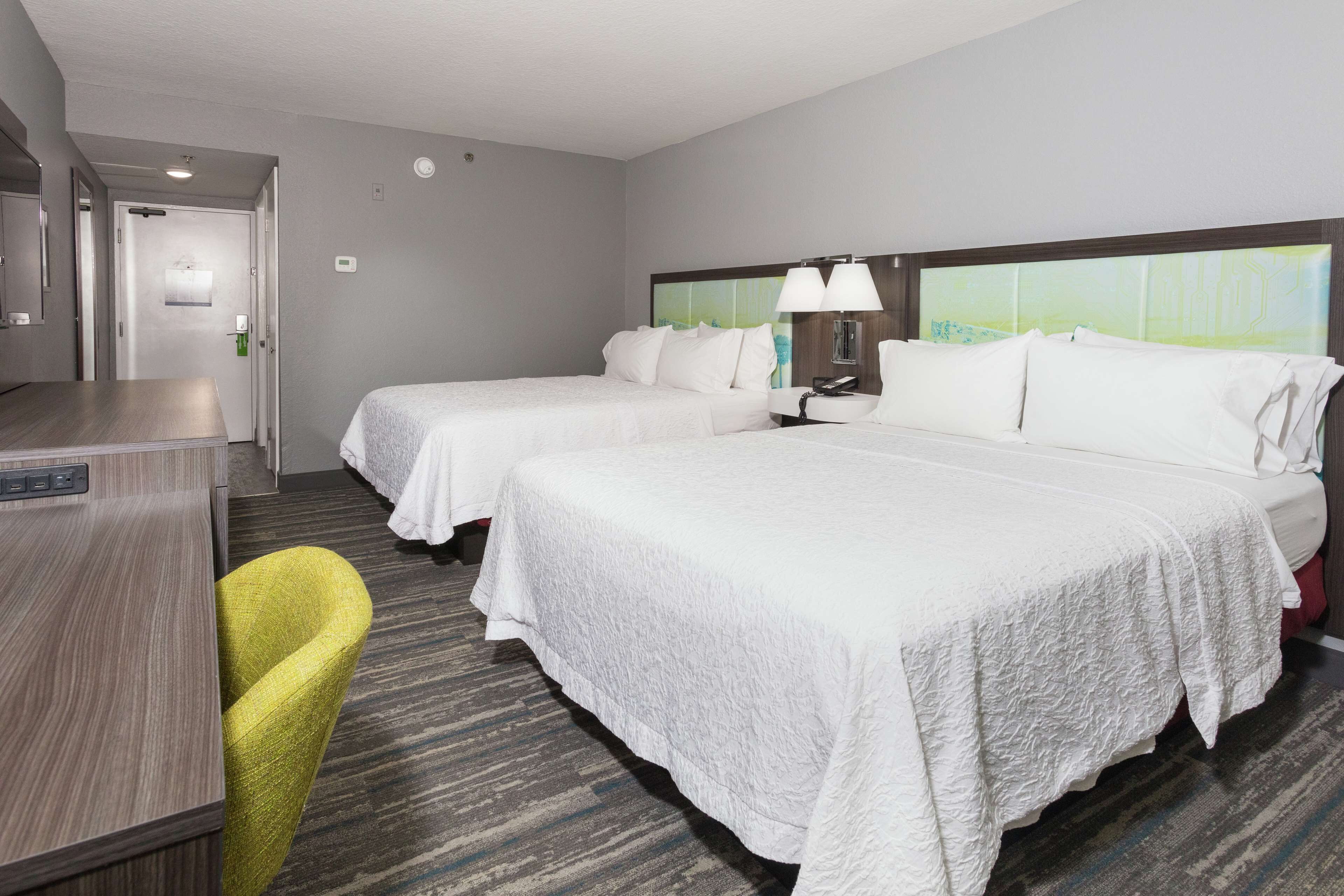 room, 2 queen beds (streetside view) | in-room safe, desk, blackout curtains, iron/ironing board