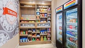 A snack and beverage display in a store with various snacks and drinks. - Hampton Inn Sault Ste Marie (Sault Ste. Marie)