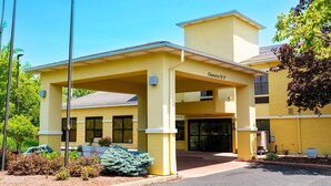 A yellow building with a covered entrance and a sign indicating a 12' clearance.