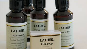 Four Lather body wash bottles and a face soap box.