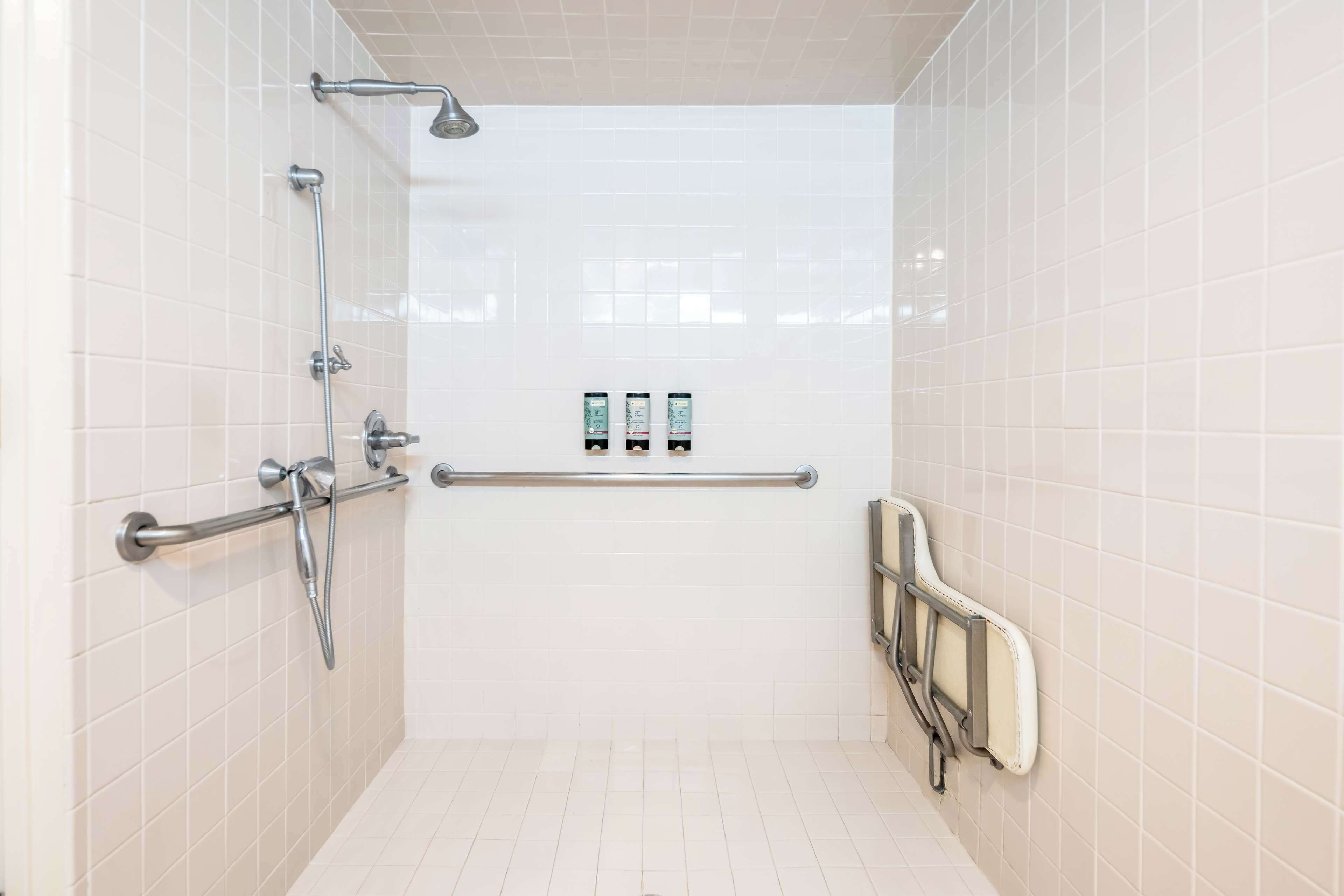 suite, 1 queen bed, accessible, jetted tub | bathroom | combined shower/bathtub, hair dryer, towels, soap