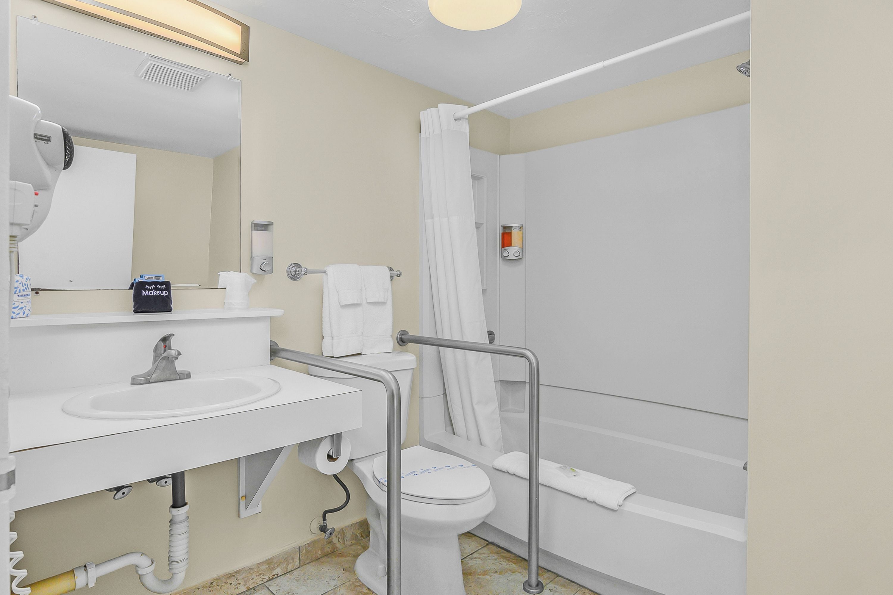 A bathroom with a sink, toilet, and shower.
