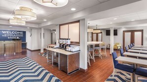 A modern hotel lobby with a reception desk, seating area, and a sign reading "WELCOME THE PRAIRIE STATE". - Hampton Inn Joliet-Plainfield I-55 (Joliet)