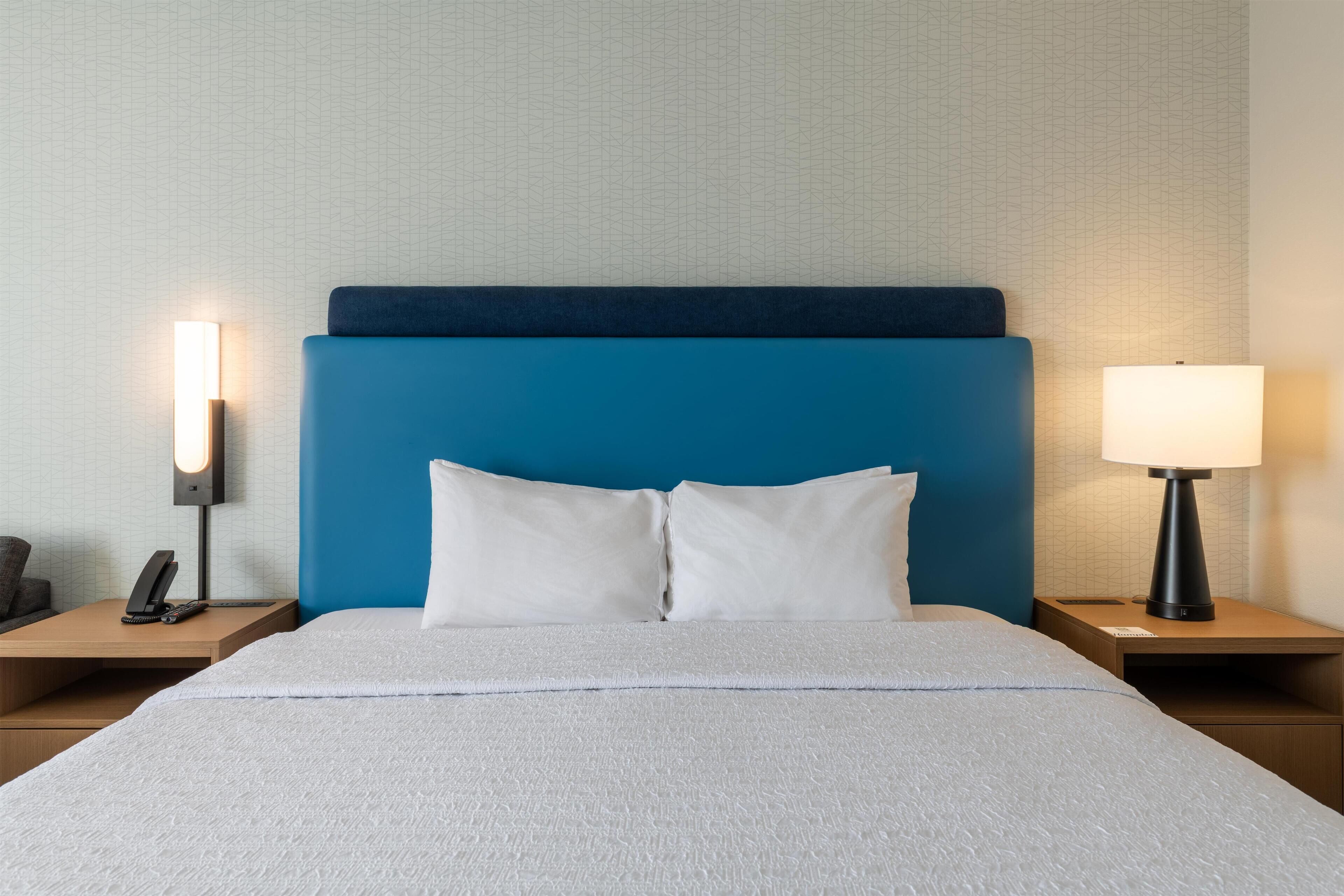 Premium bedding, desk, laptop workspace, blackout drapes