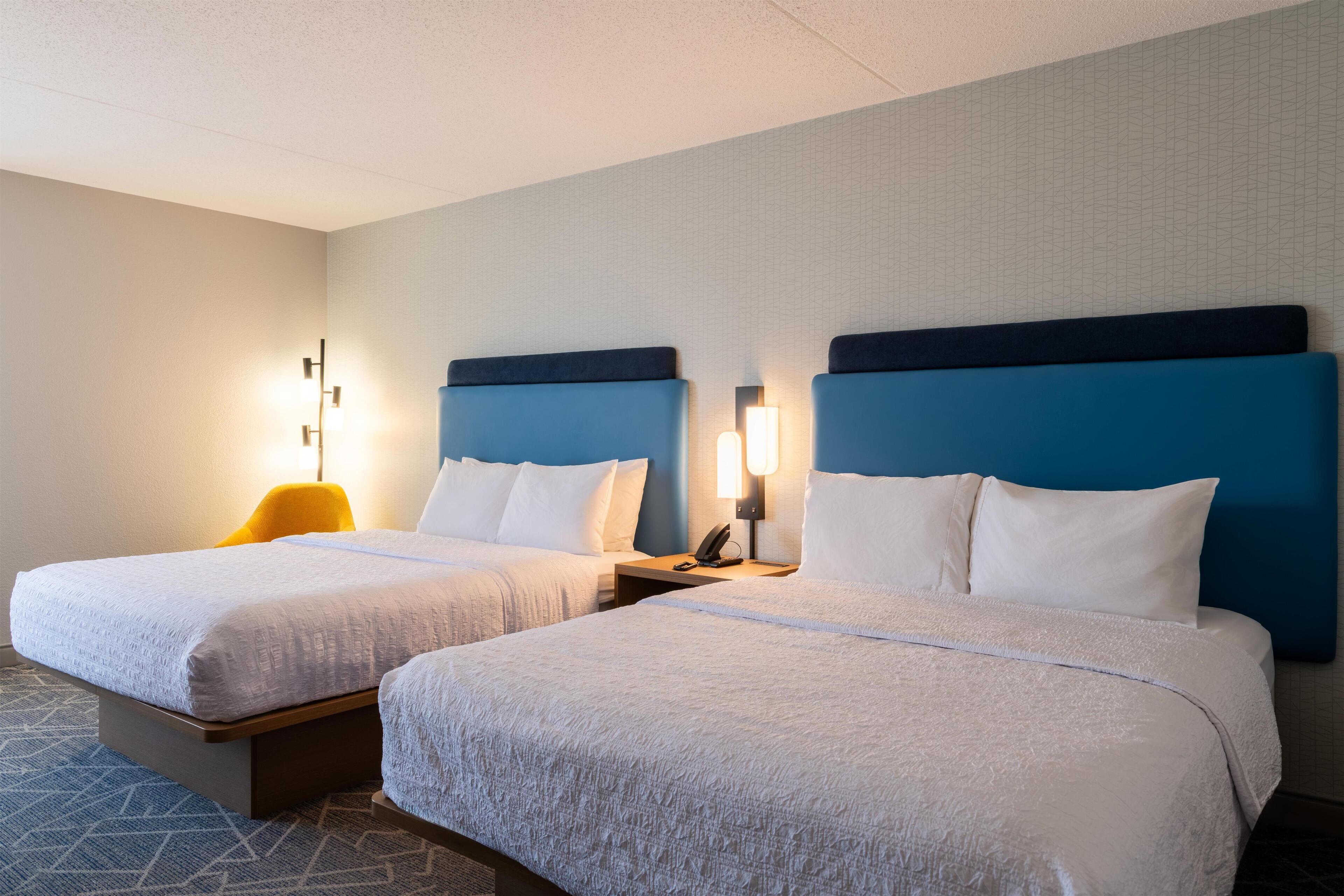 Premium bedding, desk, laptop workspace, blackout drapes