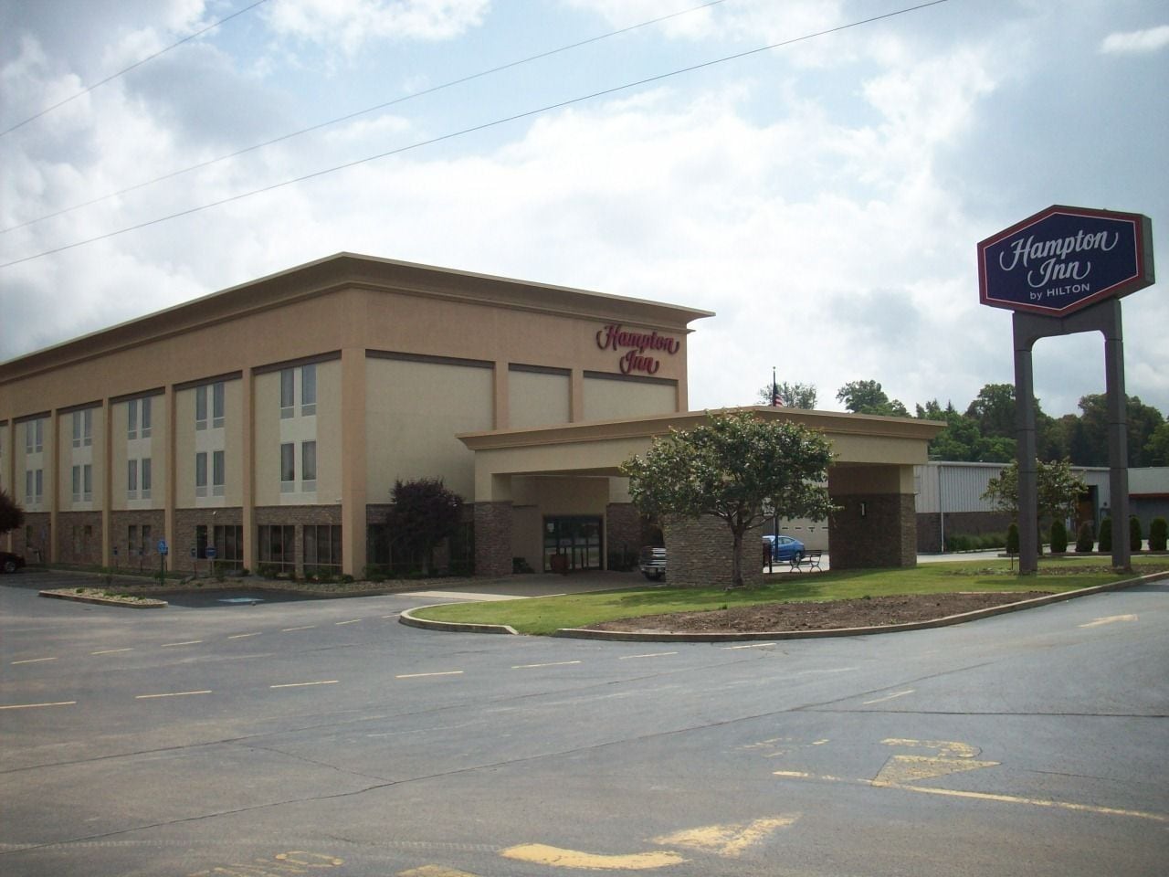 Edificio de Hampton Inn by Hilton con un estacionamiento al frente.