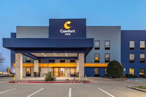A Comfort Inn hotel with a modern facade, a prominent sign, and a parking lot.