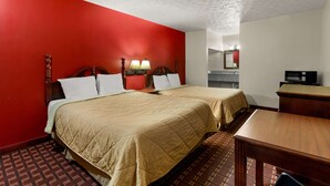 A hotel room with two beds, a desk, a chair, a TV, and a bathroom visible through an open door. - Rodeway Inn Dickson (Dickson)