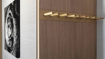 A wooden wardrobe with a coat rack.