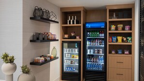 A modern interior with a refrigerator, shelves with snacks, and decorative vases. - AC Hotel by Marriott Park City (Park City)