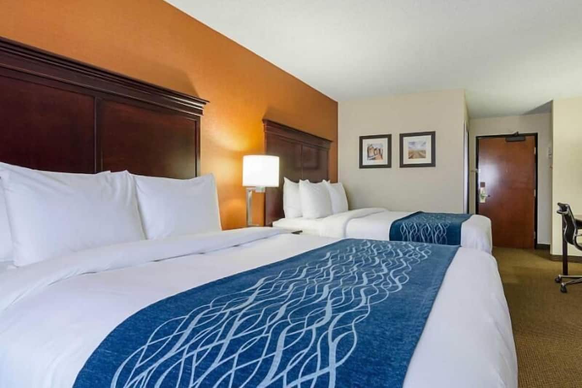 Premium bedding, desk, laptop workspace, blackout curtains