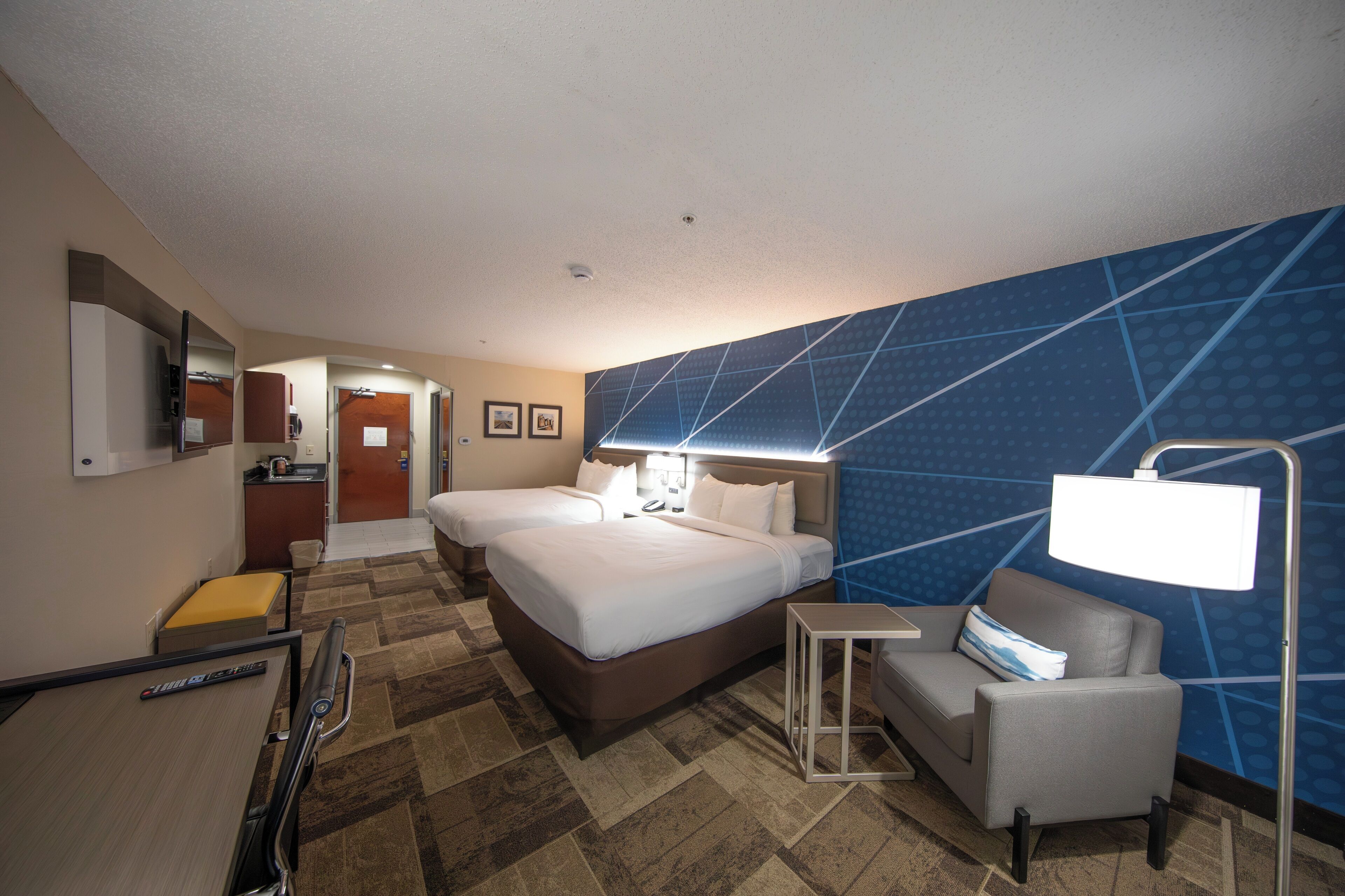 Premium bedding, desk, laptop workspace, blackout drapes