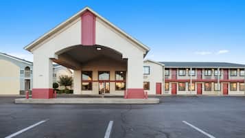 Stunning hotel entrance with a peaked roof and central accent, set within a larger complex.