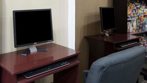 Two desks with computers, a keyboard, and a chair. - Super 8 by Wyndham San Diego Hotel Circle (San Diego)