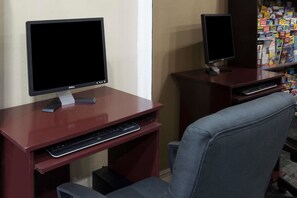 Two desks with computers, a keyboard, and a chair. - Super 8 by Wyndham San Diego Hotel Circle (San Diego)