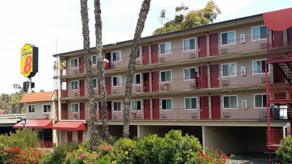 A multi-story motel with red balconies and a Super 8 sign. - Super 8 by Wyndham San Diego Hotel Circle (San Diego)