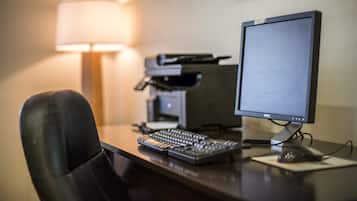 A desk with a computer, keyboard, and mouse.
