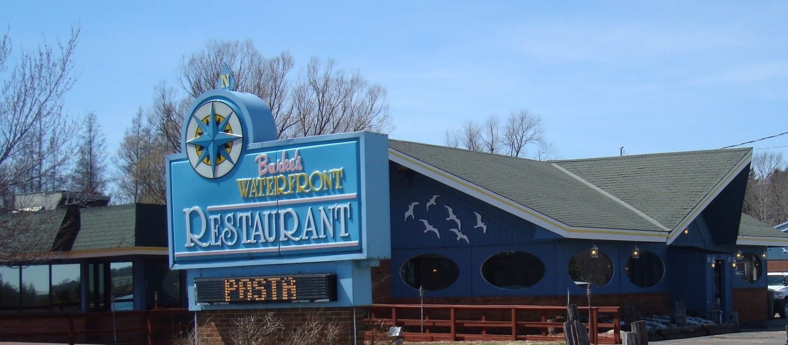 A blue building with a sign that reads "Budweiser Waterfront Restaurant."